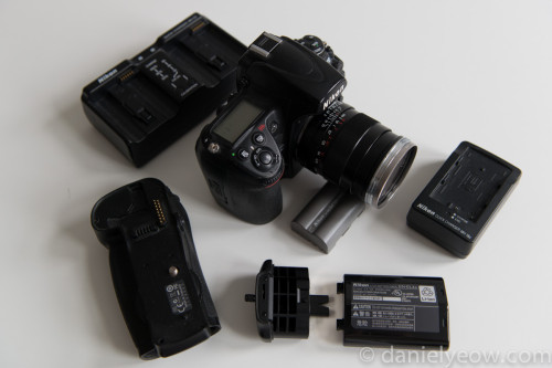 Camera body shown with battery pack, charger, and batteries